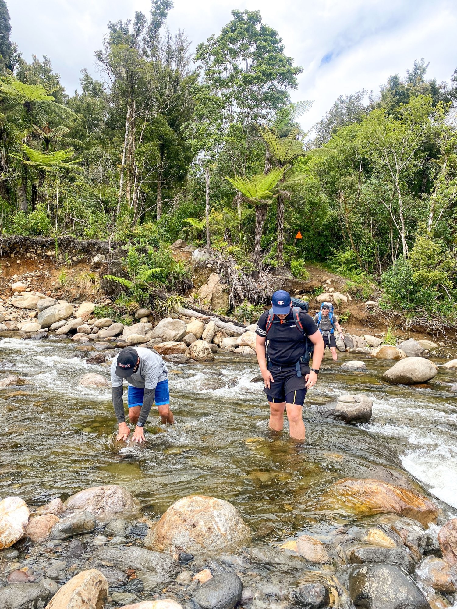 Hikers crossing stream
